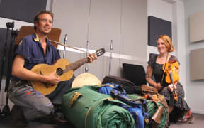 Archer and Flora Knight are hitch hiking around the South Island with their swags and tent, Guitar and Fiddle at the ready.