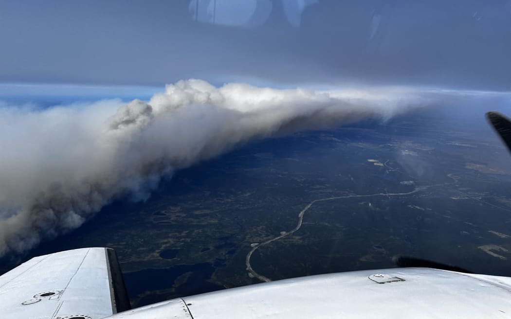 This photo taken and handout on July 12, 2024 shows an aerial view of an out-of-control wildfire near the northeastern town of Wabush in Canada. Around 9,000 people have been evacuated in northeastern Canada because of raging wildfires, officials said Saturday. (Photo by Simon Contant / AFP)