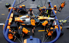 McLaren's team work on the car of driver Oscar Piastri.