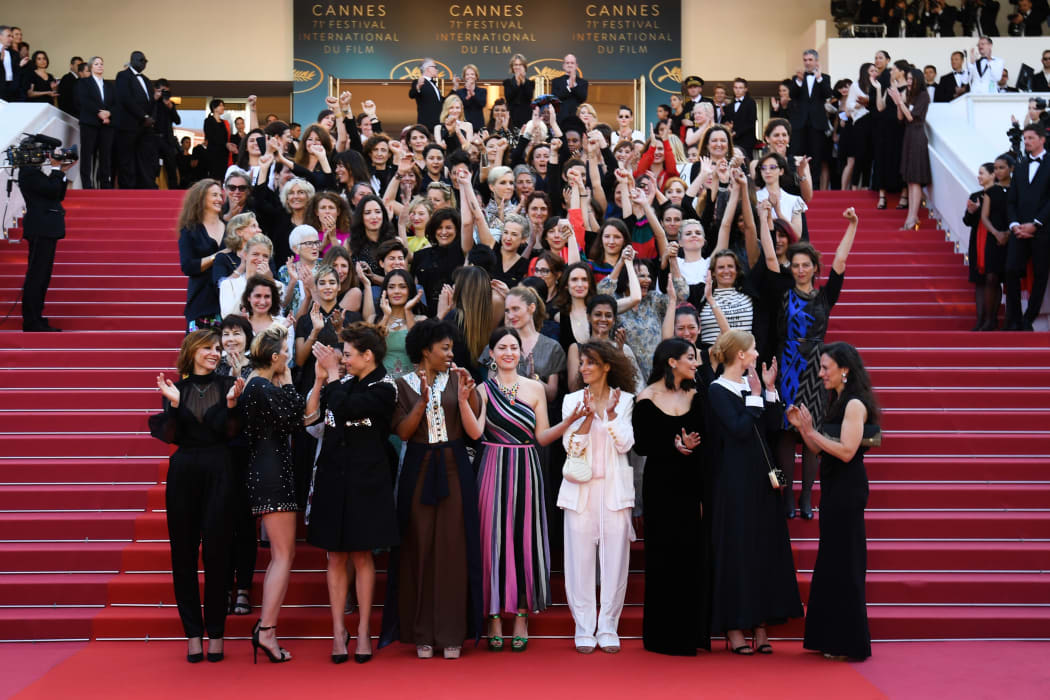 Directors, actresses and industry representatives pose on the red carpet in protest of the lack of female filmmakers honored throughout the history of the festival.