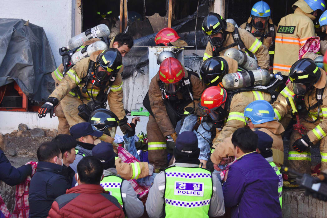 South Korean rescue workers remove the bodies of victims after a fire broke out at a hospital building in Miryang on January 26, 2018.