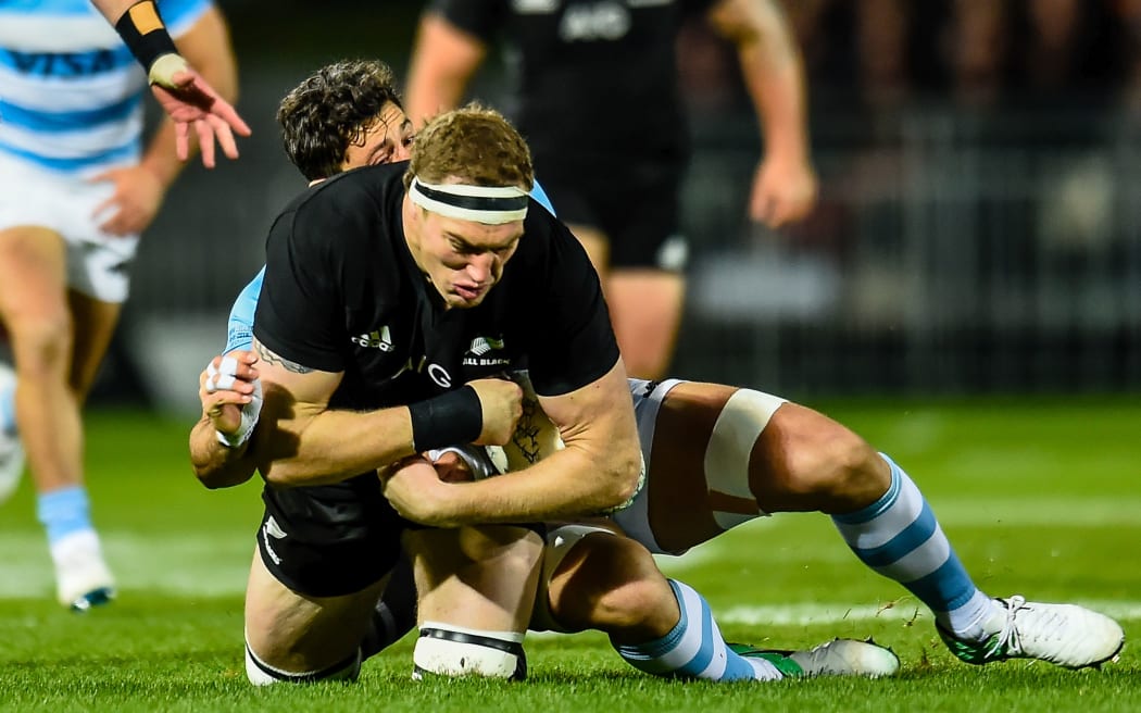 Brodie Retallick of the All Blacks gets hurt in a tackle against Argentina