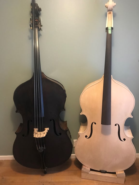 Kennedy bass beside unvarnished new bass