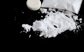 Drugs on a black surface.