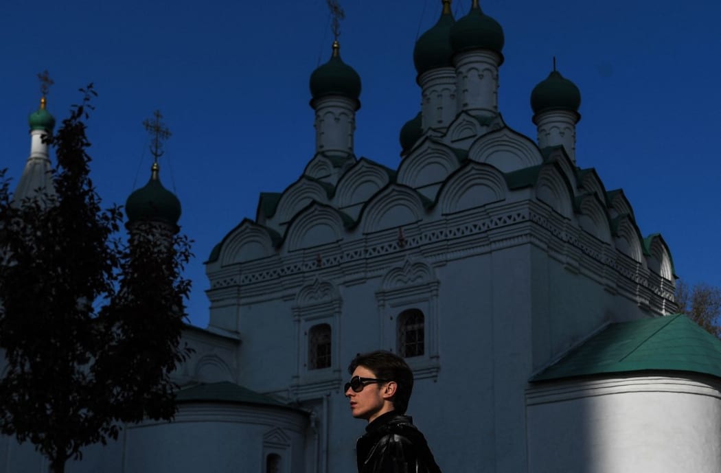 6671425 13.10.2021 A man walks past an Orthodox church, in Moscow, Russia. Pavel Bednyakov / Sputnik (