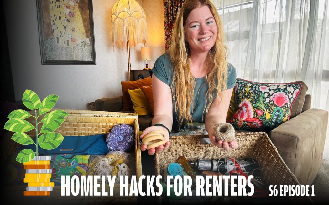 A smiling woman with long red-blonde hair sits in a cozy living room, holding tools and twine from two open wicker baskets in front of her. The room has warm lighting, colorful cushions, a patterned throw pillow, and a framed artwork on the wall. Text on the image reads: “HOMELY HACKS FOR RENTERS – S6 EPISODE 1.”
