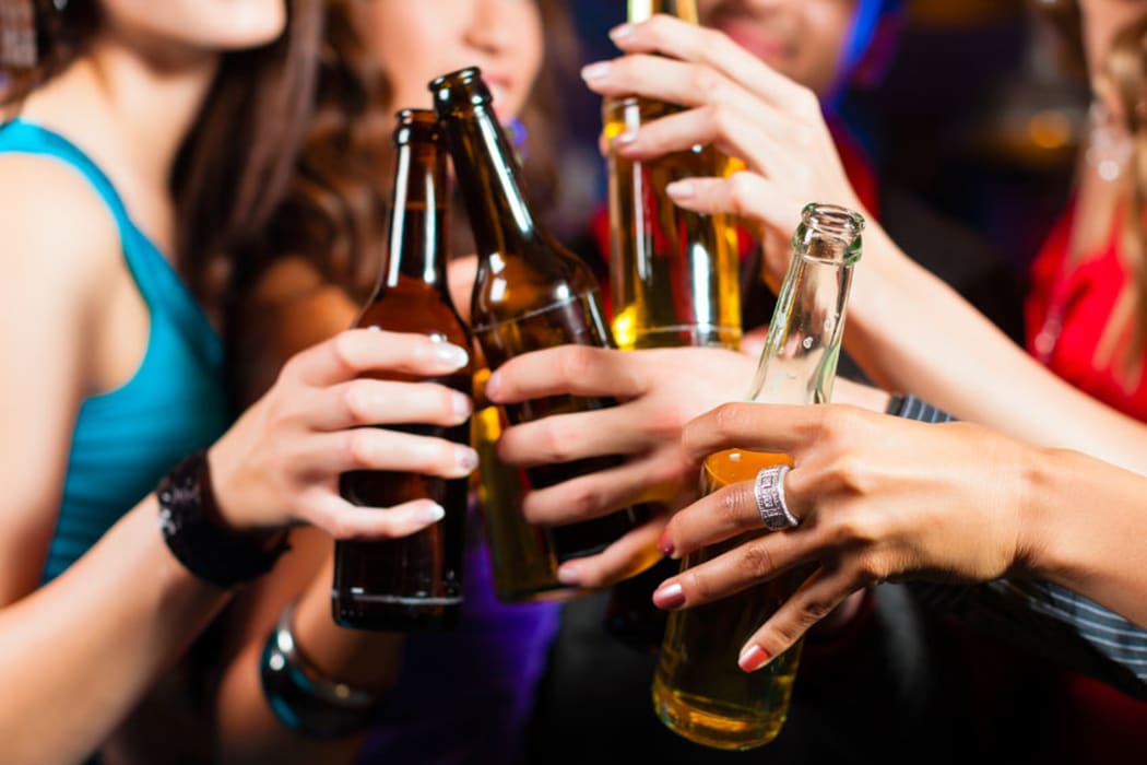 Women in a bar with beers