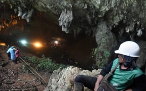 Rescue personnel at the opening of the Tham Luang cave in Khun Nam Nang Non Forest Park.