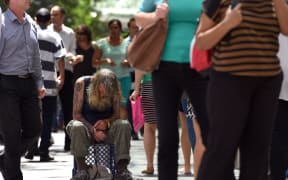 A man begs for money in Sydney's central business district