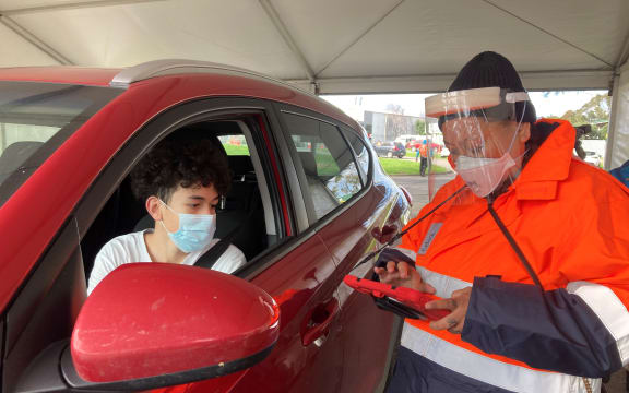 Te Rangiura Royal with his mum Matire Harwood at Auckland's first drive-thru vaccination site.