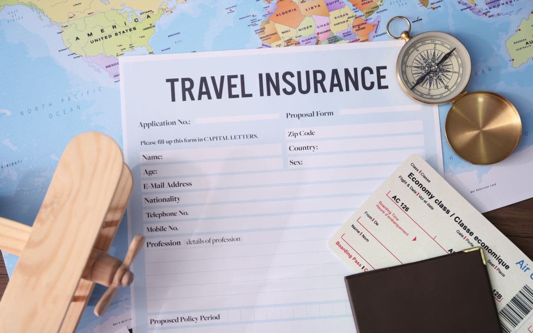 Blank travel insurance form and map on background