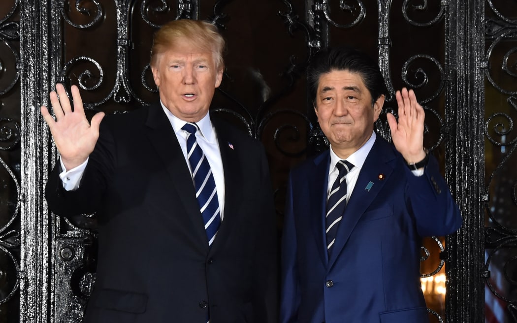 US President Donald Trump greets Japans Prime Minister Shinzo Abe before a summit meeting at Mar-a-Lago in Palm Beach, Florida.