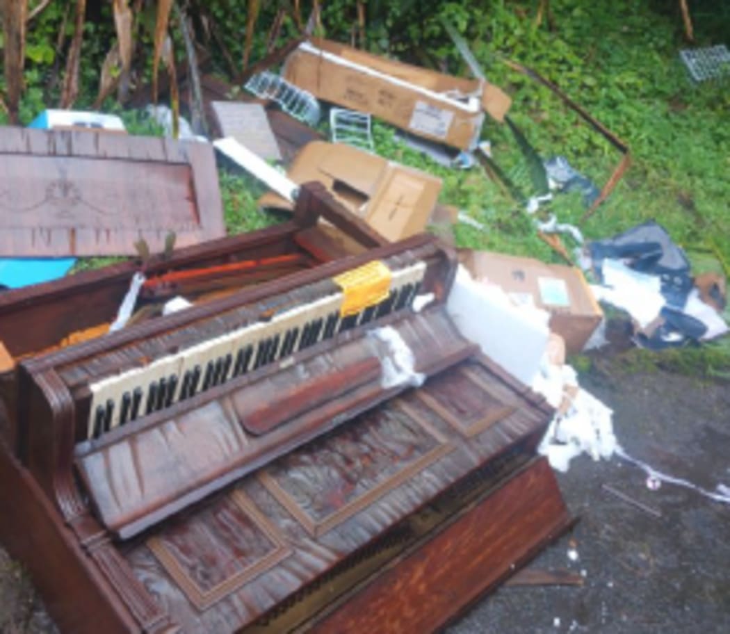 A discarded piano left in a public area, contributing to the city’s illegal dumping problem.