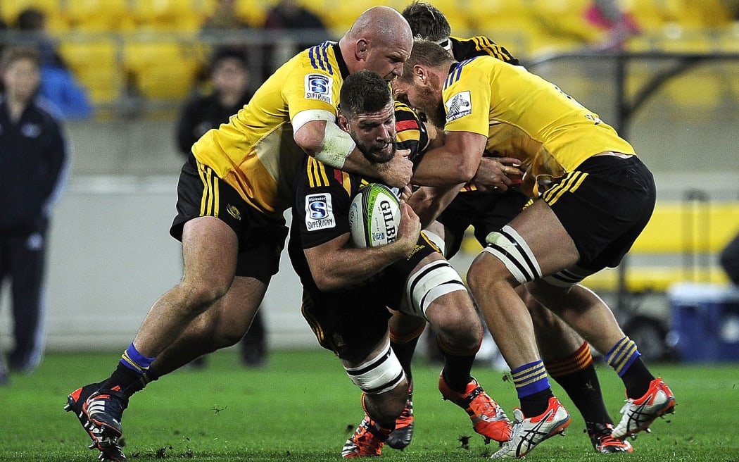 The Chiefs' Michael Leitch is tackled by Ben Franks