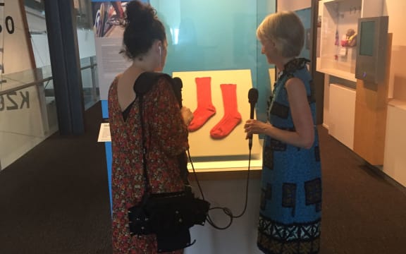 Noelle McCarthy and Te Papa curator Stephanie Gibson admire the red socks on display.