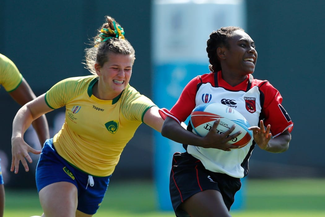 Papua New Guinea's Chelsea Garesa races away from the Brazil defence.
