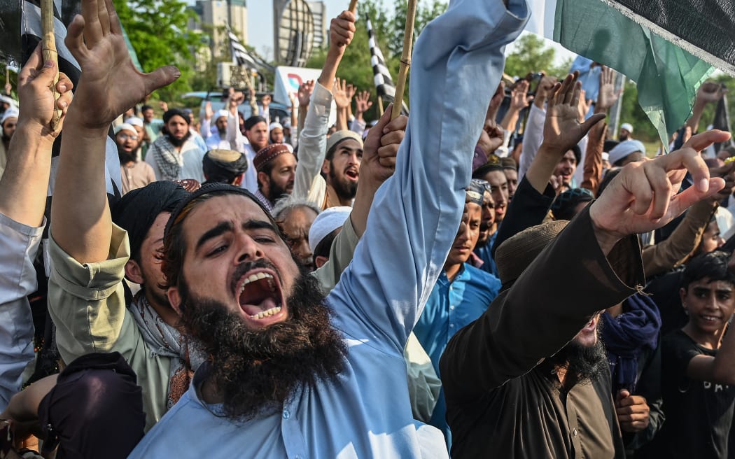 Supporters of Jamiat Ulema-e-Islam Fazal (JUI-F) shout slogans during an anti-India protest in Islamabad on May 9, 2025. Pakistan charged India on May 9 with bringing the nuclear-armed neighbours "closer to a major conflict", as the death toll from three days of missile, artillery and drone attacks passed 50. The bloody escalation comes after an attack on tourists last month in the Indian-run part of disputed Kashmir that killed 26 people and which New Delhi accused Islamabad of backing – an allegation Pakistan denied. (Photo by Aamir QURESHI / AFP)