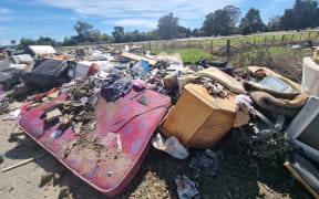 The other route into the industrial zone via Awatoto Road is closed. Residents are volunteers have been bringing trailer load after trailer load of waste and ruined furniture to an informal dump site on the corner of Eriksen and Awatoto roads. They say the local council knows about it and plans to clear it.