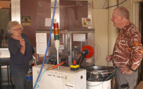 Carolyn Livingstone and Brian Frances (Skin) at the poppy making machine.