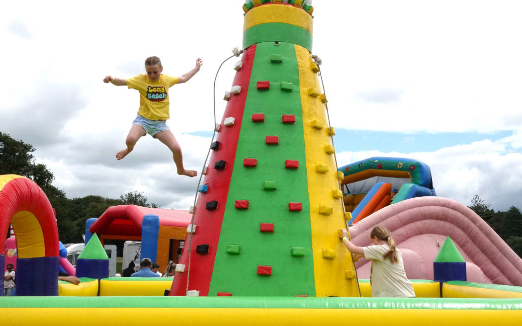 Kerikeri 10-year-old Gee Wright finds the shortest way down from an inflatable climbing tower, on 9 November, 2024.