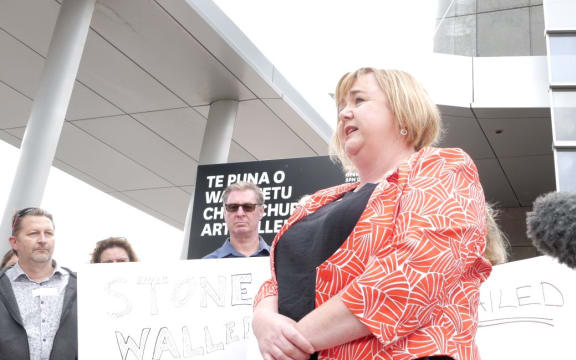 Megan Woods speaks to residents with quake damaged homes who are protesting the thousands of unresolved  earthquake insurance claims.