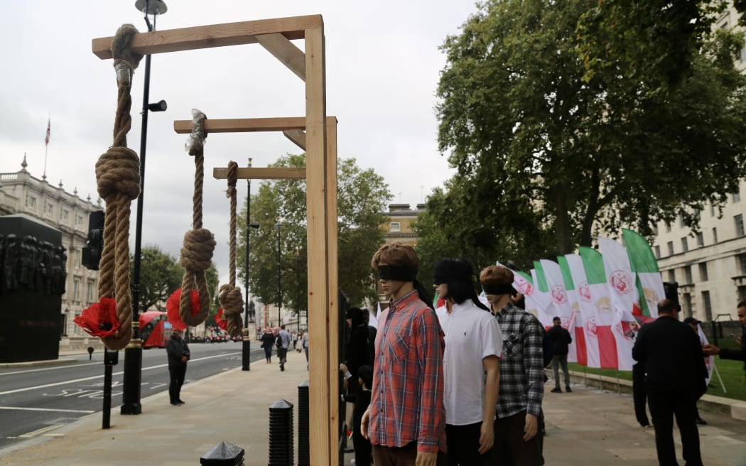 Protesters gather to stage a protest against Iranian President Ebrahim Raisi and executions in Iran ahead of World Day Against the Death Penalty (10 October) in London, United Kingdom on October 08, 2021.