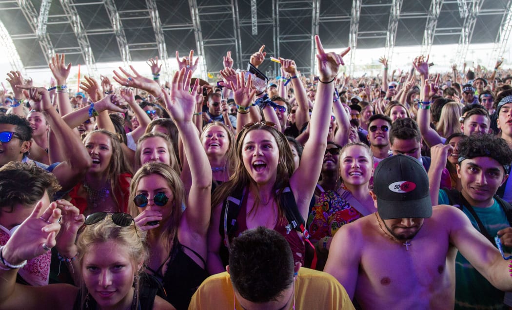 (FILES) In this file photo taken on April 15, 2018 fans cheer as Petit Biscuit performs at the Coachella Music and Arts Festival in Indio, California, -