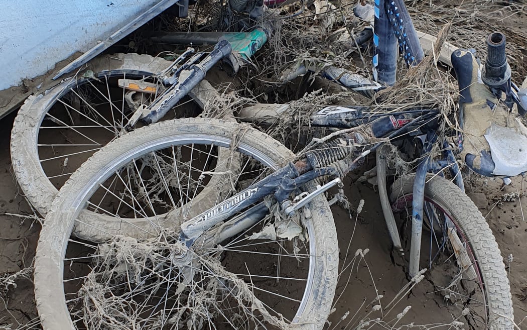 Why so many kids' bikes were tangled in the flood detritus seems a strange puzzle