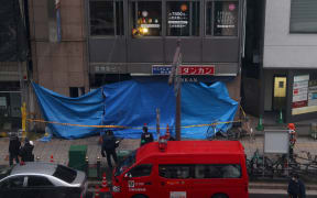 Emergency vehicles are seen in front of an office building, where a fire broke out in Osaka on December 17,2021.
