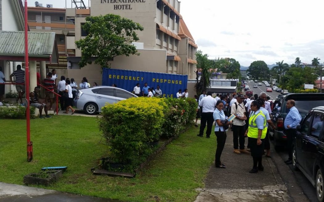 Staff evacuate from the Fiji Red Cross building in Suva.