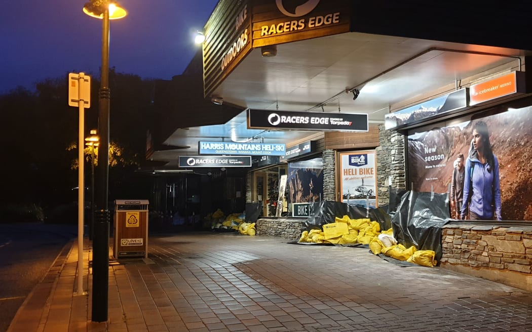 Stores in Wanaka are prepared for flooding with sandbags and plastic sheeting.