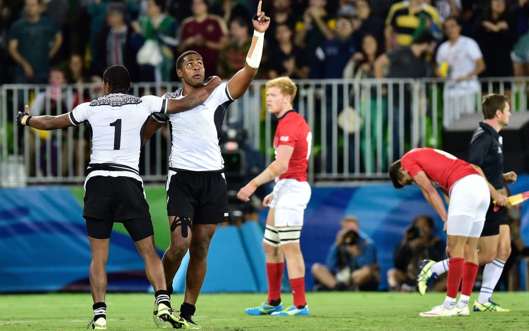 Fiji's Viliame Mata (2nd left) and Apisai Domolailai (L) celebrate Olympic gold.