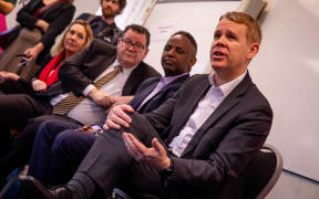 Labour leader Chris Hipkins (c) with Wellington Central Labour candidate Ibrahim Ohmer speaking to staff and students at KiwiClass Multicultural Support Services in Mt Cook, Wellington.