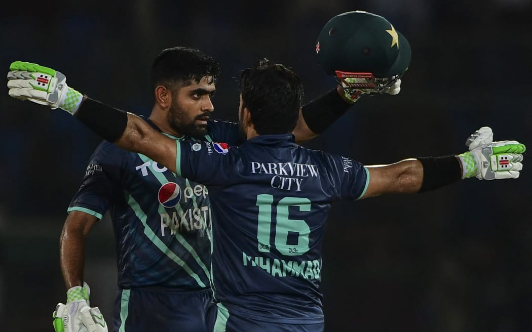 Pakistan's captain Babar Azam (L) and teammate Mohammad Rizwan celebrate after their win at the end of the second Twenty20 international cricket match between Pakistan and England at the National Cricket Stadium in Karachi on September 22, 2022. (Photo by Asif HASSAN / AFP)