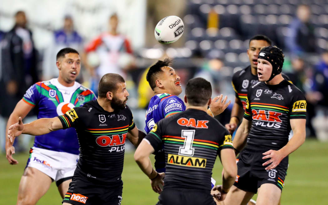 Players contest for a kick. Penrith Panthers v Vodafone Warriors