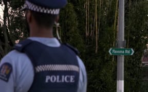 A police officer stands outside the house on Favona Road where the two-year-old was found dead on 2 June 2016.