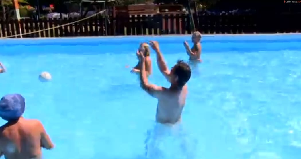 picture of TVNZ's Seven Sharp reporter frolicking naked with naturists in a pool.