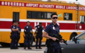 Armed Hong Kong police stand guard before the arrival of China's National People's Congress Standing Committee Chairman Zhang Dejiang.