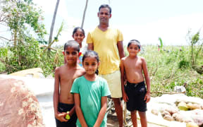 Saiyaz Aziz and his  family in Lovu settlement near Lautoka, Fiji. Happy to be alive