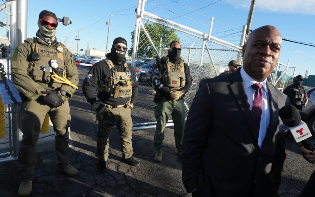 Mayor Ras Baraka of Newark speaks to the press near ICE agents at a demonstration outside an immigrant detention centre in Elizabeth, New Jersey May 7, 2025. The Mayor arrived at the gates of Delaney Hall to inspect the previously vacant prison that is being converted into an immigrant detention center. Delaney Hall has the ability to hold over a 1000 people, and the detention facility, privately owned by The GEO Group, holds a contract with the federal government to house people arrested by ICE. (Photo by TIMOTHY A. CLARY / AFP)