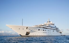 Gigantic big and large luxury mega or super motor yacht on the blue ocean.