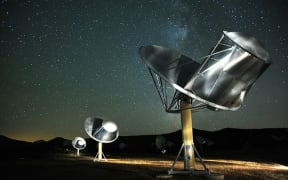 The Allen Telescope Array at night with stars above.