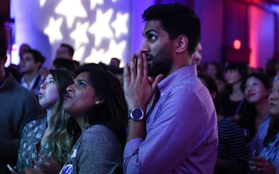 People react to live results while attending a midterm election night party hosted by the Democratic Congressional Campaign Committee in Washington, DC.