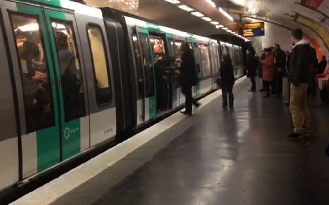 A video grab shows Chelsea fans packed onto a Paris Metro train pushing a passenger to prevent him from boarding.