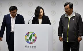 Taiwan President Tsai Ing-wen (C) speaks during a press conference at the headquarter of ruling Democratic Progressive Party (DPP) in Taipei