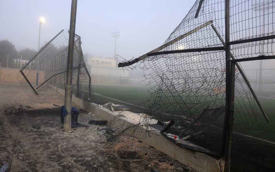 A damaged gate and debris at a football pitch after a reported strike fell in Majdal Shams village in the Israeli-annexed Golan area on 28 July, 2024.
