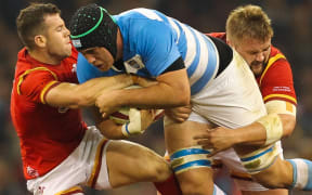 Argentina's Matías Alemanno is tackled by Wales Gareth Davies and Tomas Francis.