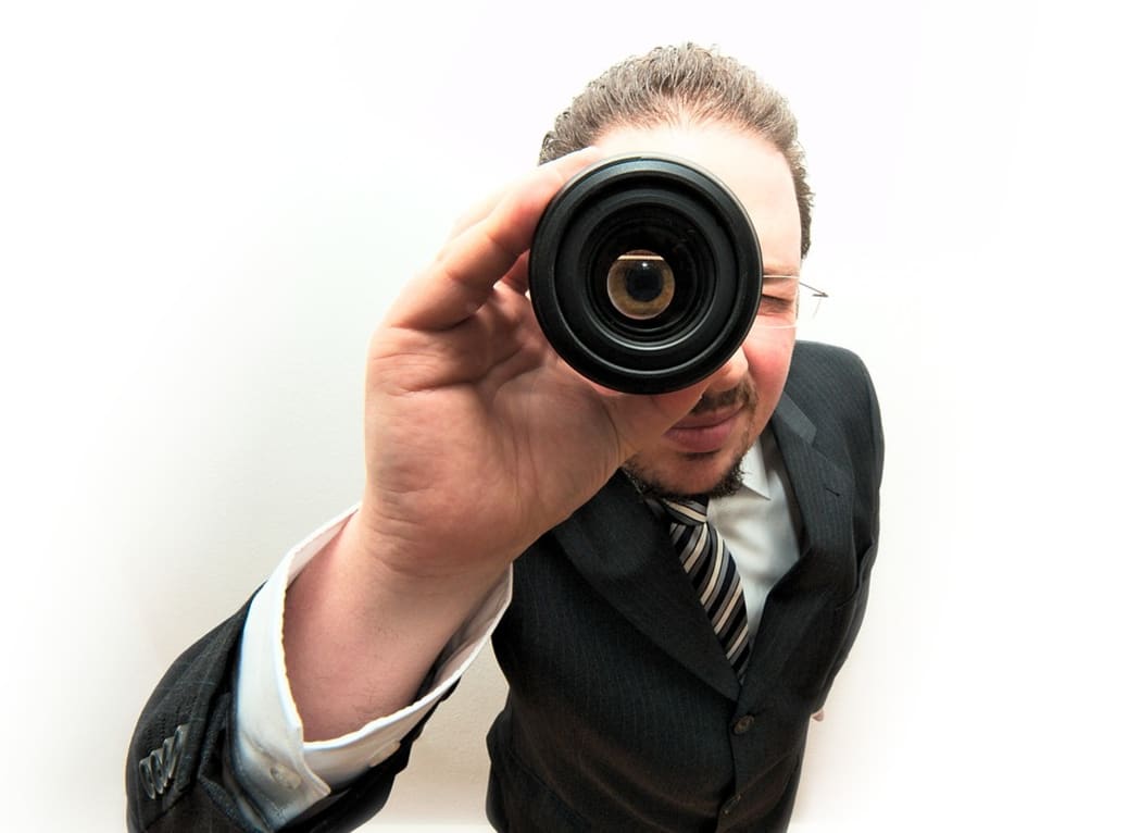 Man looking through lens