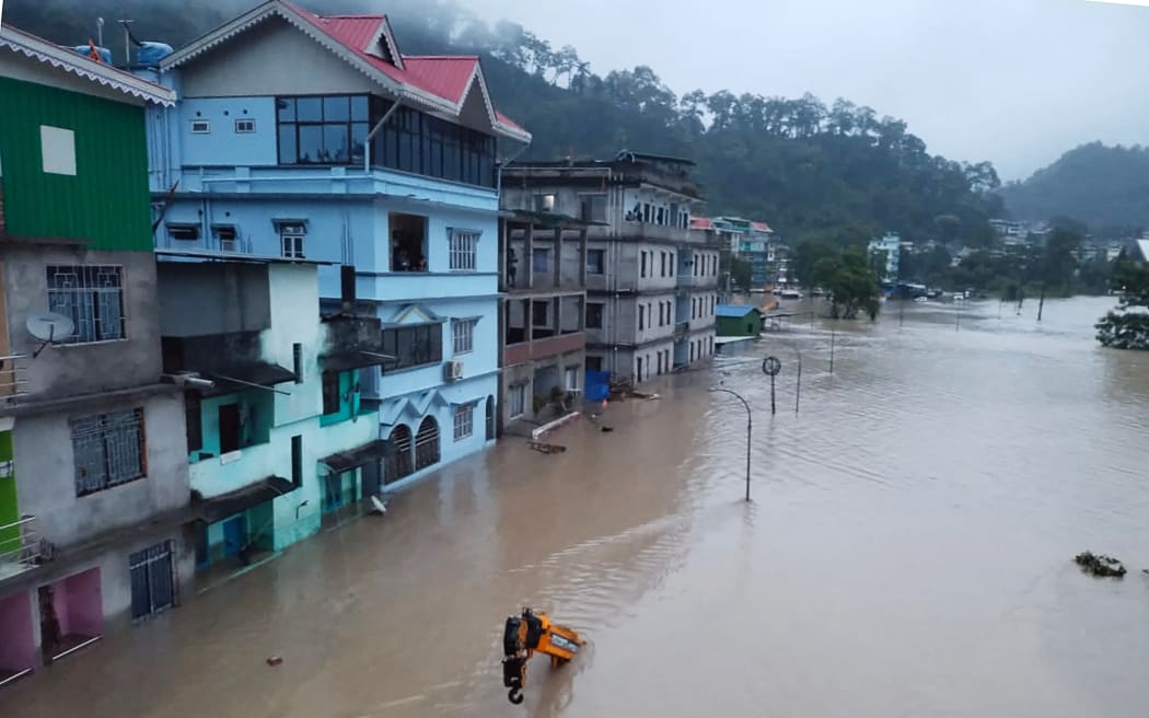 This handout photograph released by the Indian Army and taken on October 4, 2023, shows a flooded street in Lachen Valley, in India's Sikkim state following a flash flood caused by intense rainfall. The Indian army said on October 4 that 23 soldiers were missing after a powerful flash flood caused by intense rainfall tore through a valley in the mountainous northeast Sikkim state. (Photo by INDIAN ARMY / AFP) / RESTRICTED TO EDITORIAL USE - MANDATORY CREDIT "AFP PHOTO / Indian Army" - NO MARKETING NO ADVERTISING CAMPAIGNS - DISTRIBUTED AS A SERVICE TO CLIENTS