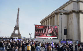 People gather in Paris to watch the Congress at Versaille vote to enshrine the right to abortion in France's constitution.